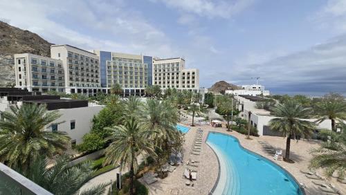 arial view of a resort with a pool and palm trees at Solo Realty Apartments at Address Residence Fujairah in Sharm