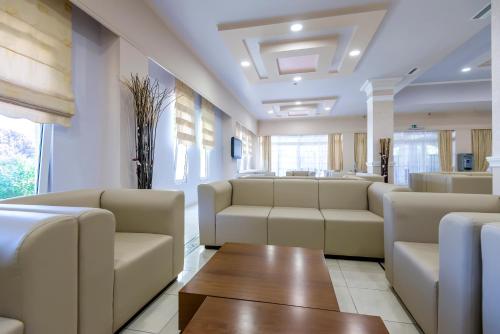 a waiting room with couches and a table at Gaia Royal in Mastichari