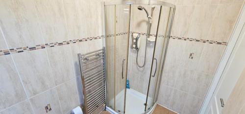 a shower with a glass door in a bathroom at 12A-1 Stobhill Road in Arniston