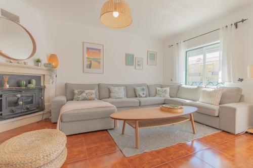 a living room with a couch and a coffee table at Baleal Happiness Surf House in Ferrel