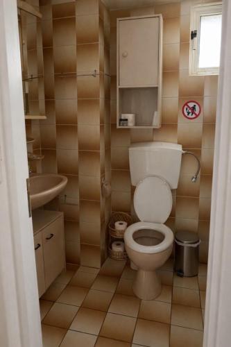 a bathroom with a toilet and a sink at Sea View House B in Péra Mélana