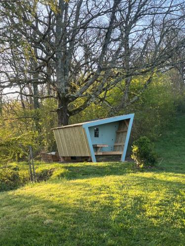 a small house in a field next to a tree at Cabane étape in Idrac-Respailles