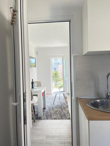 a kitchen with a door leading to a dining room at White Rose 2 in Bar