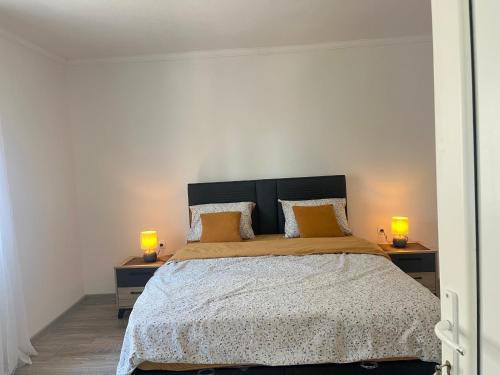 a bedroom with a large bed with two lamps on tables at White Rose 2 in Bar