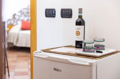 a bottle of wine sitting on top of a refrigerator at La Venere in Taormina