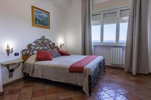 a bedroom with a bed and a large window at La Venere in Taormina