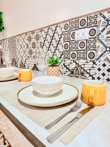 a table with plates and utensils on top of a table at Apartamento #10 in Alajuela
