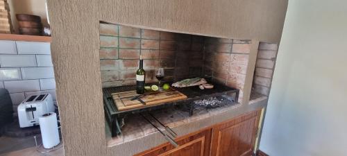 a kitchen with a stove with a bottle of wine at Maranatha in Rufino