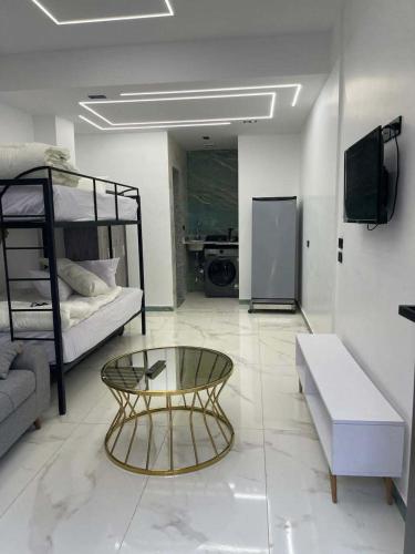 a living room with a coffee table and bunk beds at Luxury Studio in 6october in 6th Of October