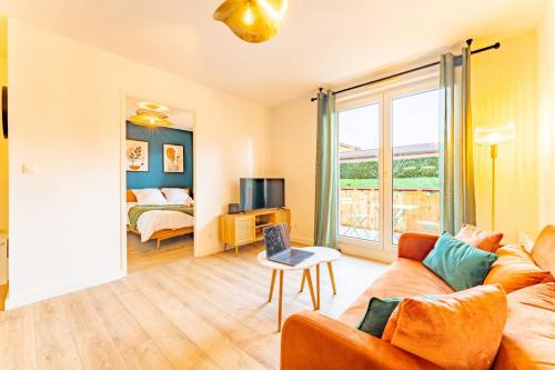 a living room with a couch and a bed at La bastide de Montech in Montech
