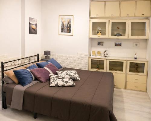 a bedroom with a large bed with pillows on it at Un Raggio di Sole - a due passi dal mare in Montesilvano