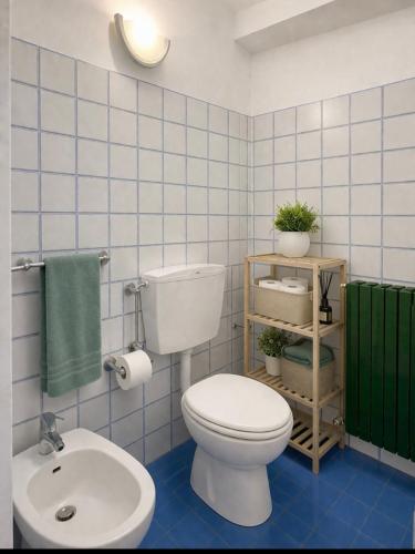 a bathroom with a white toilet and a sink at Pino Center in Pino Torinese