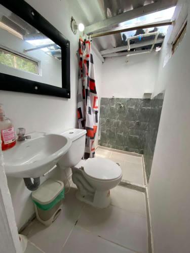 a bathroom with a toilet and a sink at Apartamentos de madera SenSunset Necocli in Necoclí