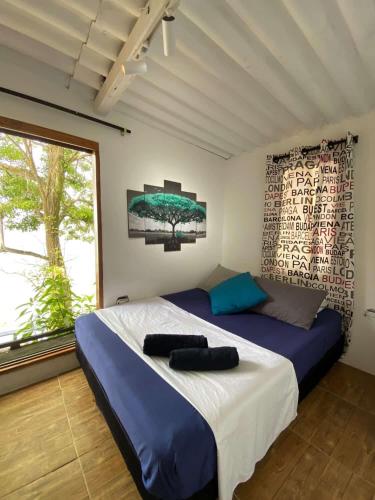 a bedroom with a large bed and a window at Apartamentos de madera SenSunset Necocli in Necoclí
