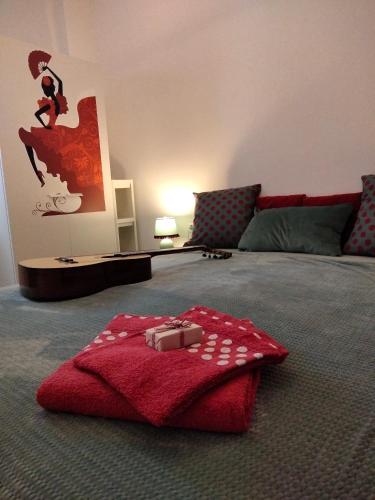 a bedroom with a red blanket on the floor at Casa Flamenca in Granada