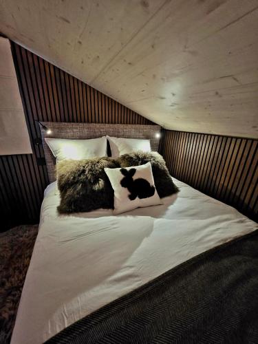 a bedroom with a large bed with fur pillows at Tiny House Annecy in Annecy