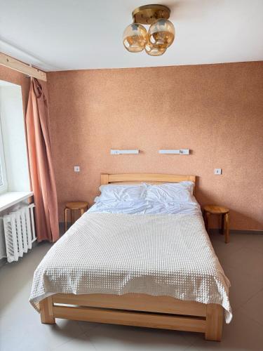 a bedroom with a bed with a brown wall at Pilot House in Mykolaiv