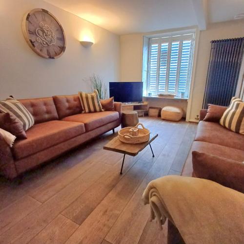 a living room with a couch and a table at The Homestead -Cosy Cottage for 2 in Wells next the Sea