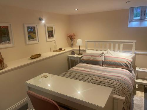 a bedroom with a bed with a table and chairs at Trailside in Headingley in Leeds