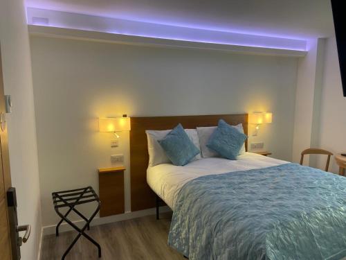 a bedroom with a bed with a blue light above it at The Old Printworks, Kirkwall in Orkney