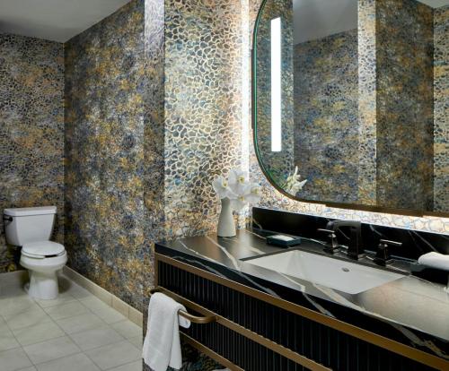 a bathroom with a sink and a mirror at Renaissance Shoals Resort & Spa in Florence