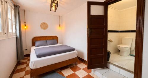 a bedroom with a bed and a shower and a toilet at Dahab Hostel in Cairo