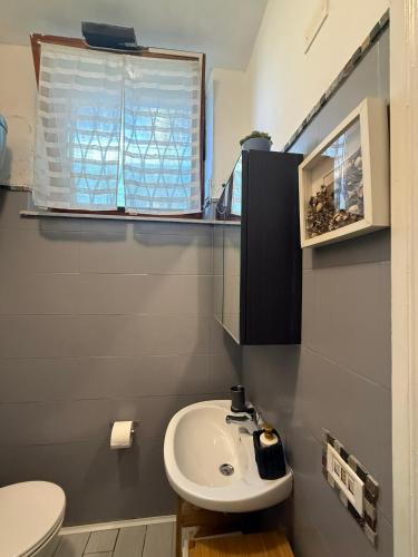 a bathroom with a sink and a toilet and a window at La Casa di Ornella in Rome