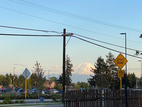a snow covered mountain in the distance with a street sign at Peaceful Home-Centrally Located West Hill, Kent in Kent