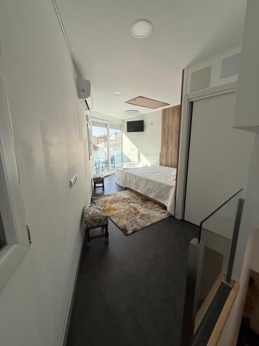 a room with a bed and a room with a window at Mabel House Suites in Mijares