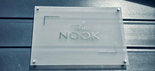 a sign that says the nook sitting on a table at The NOOK in Kinlochleven