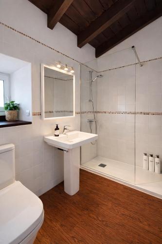 a white bathroom with a sink and a shower at Casa en Vilallobent Cerdanya ideal familias by CalQuerol in Vilallovent
