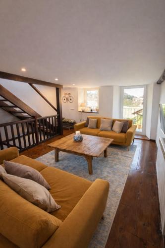 a living room with a couch and a coffee table at Casa en Vilallobent Cerdanya ideal familias by CalQuerol in Vilallovent