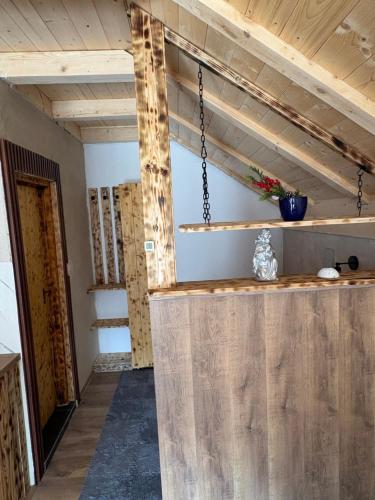 a room with wooden walls and a wooden ceiling at Mountains story in Bistrica Lipovska