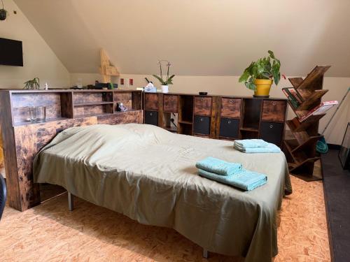 a bedroom with a bed with two towels on it at Le Studio d'Instant Nature in Alexain