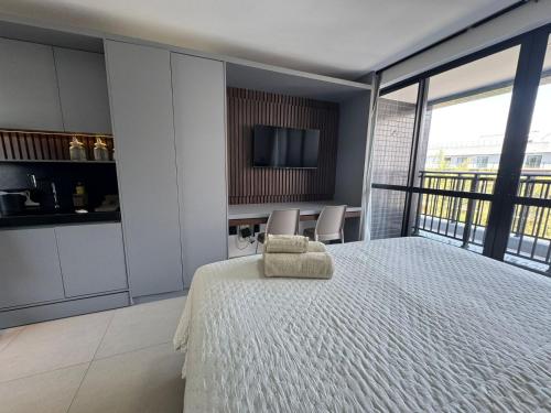 a bedroom with a bed and a tv on a wall at Get One - João Pessoa in João Pessoa