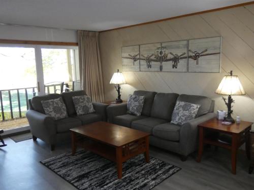 a living room with a couch and a table at No Worries at Summit Village! in Bellaire