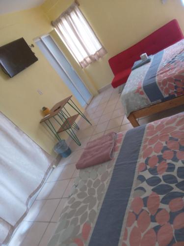 a view of a bedroom with a bed and a chair at Departamento full equipped in Puerto Escondido
