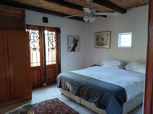 a bedroom with a bed and a ceiling fan at Natalie's Garden Cottage, in McGregor