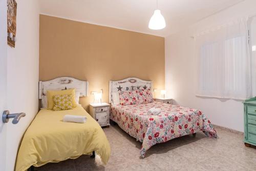 a bedroom with two beds and a window at CHiC APARTMENT in Tossa de Mar