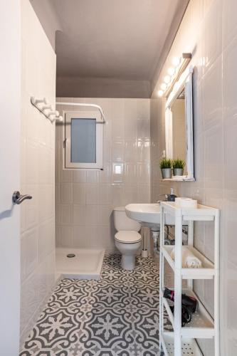 a white bathroom with a sink and a toilet at CHiC APARTMENT in Tossa de Mar