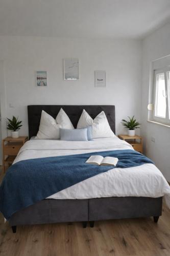 a bedroom with a large bed with a blue blanket at GUESTHOUSE Kastel Novi in Kaštela