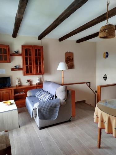 a living room with a couch and a table at Apartamentos Turísticos Rural Los Tinaos in Bubión