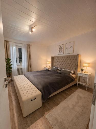 a large bedroom with a large bed with a bench at Ferienwohnung Wald-Michelbach in Wald-Michelbach