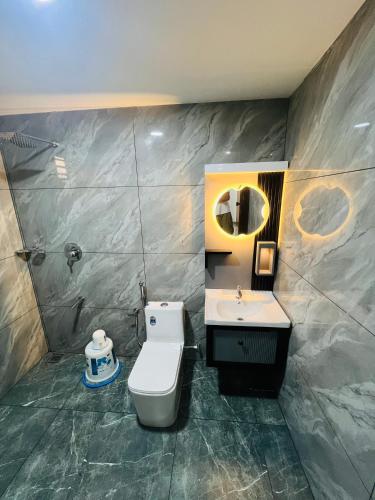 a bathroom with a toilet and a sink at Elowen Villa in Mananthavady