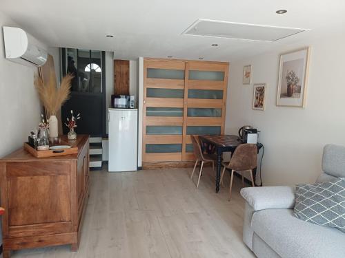 a kitchen and living room with a table and a couch at Studio en Luberon in La Bastidonne
