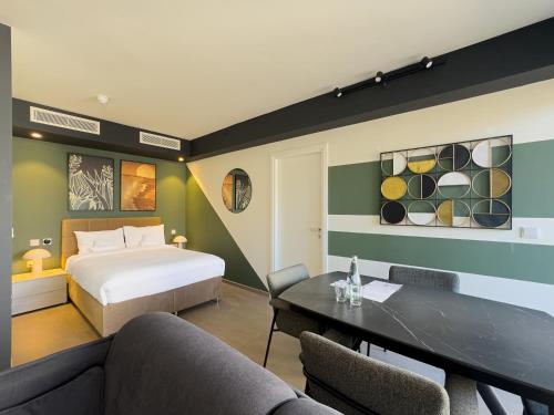 a hotel room with a bed and a table at Mercury Suites Premium Apartments With Pool Access in St. Julianʼs
