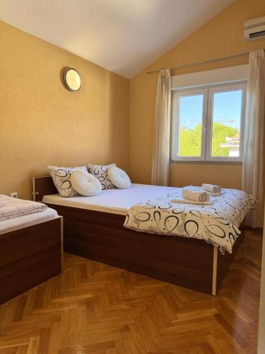a bedroom with two beds and a window at Central Stay Mostar - Apartments & Rooms in Mostar