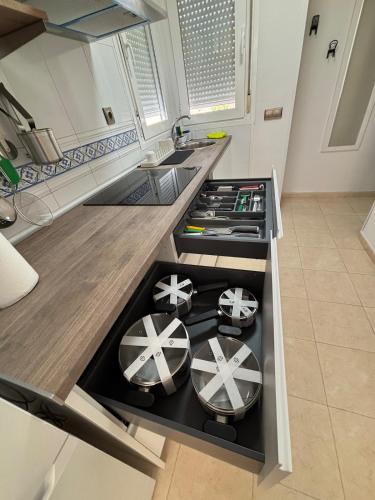 a kitchen with a stove top oven in a kitchen at Taína La Encina in Vícar
