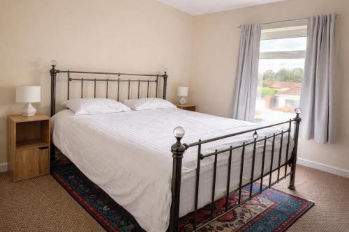 a bedroom with a large bed and a window at London Heathrow Accommodation in Hillingdon