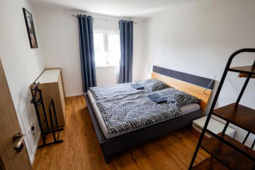 a bedroom with a bed and a window and a ladder at Villa de Calma Samorin in Šamorín